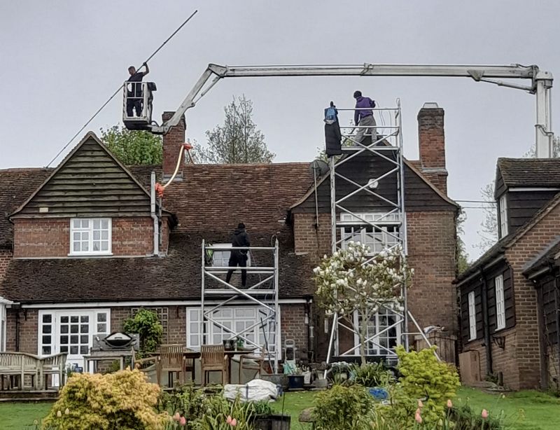 The Moss Cleaners using cherry picker and scaffolding to clean roof safely and professionally in Corsham, Wiltshire